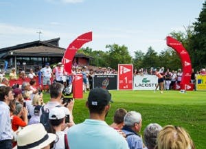 a female athlete teeing off in a golf competition